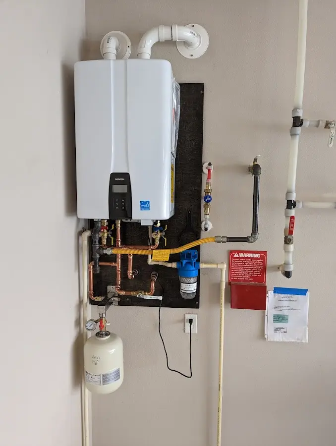 Professional plumber installing copper piping in a Winfield home